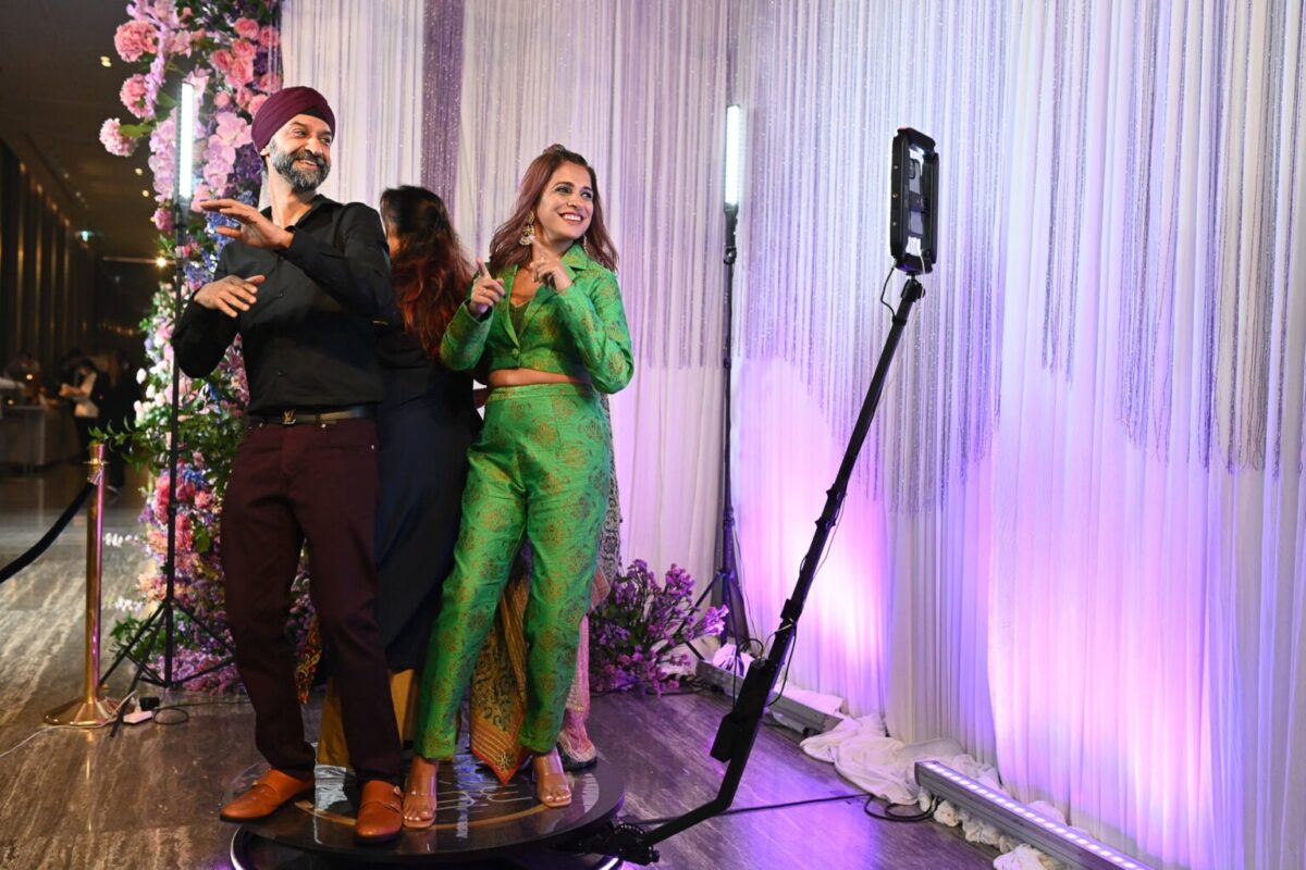 Sikh Indian Punjabi husband and wife enjoying photo booth rental in Thailand
