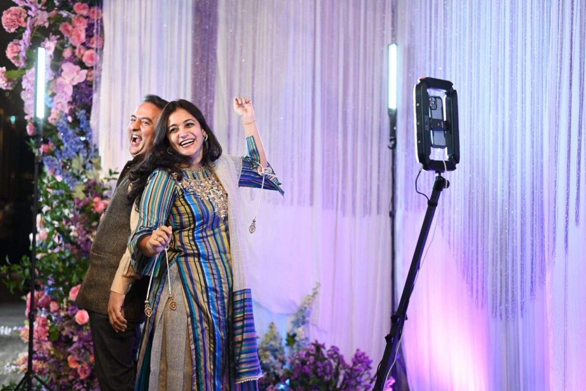 Indian Husband and wife enjoying photo booth rental experience at BOOTH+ Thailand event